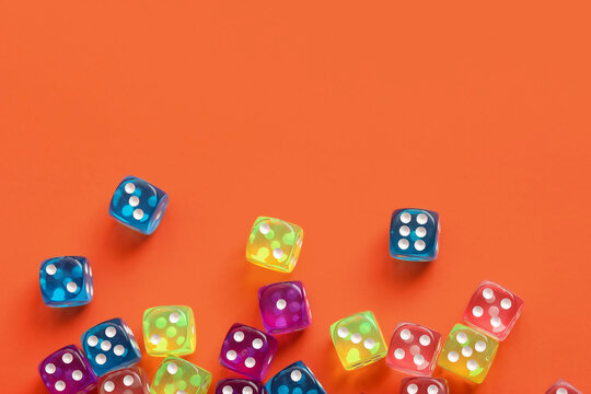 Colorful game dices on orange background