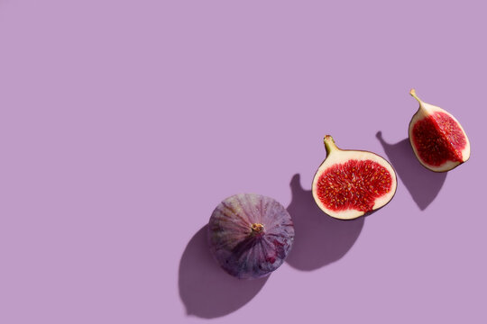 Fresh ripe figs on lilac background
