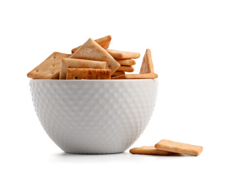 Bowl with tasty crackers on white background