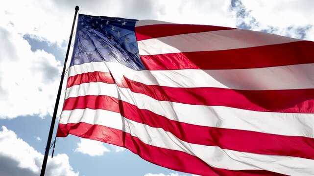 Patriotic American Flag Flying Outdoors Against Dramatic Sky