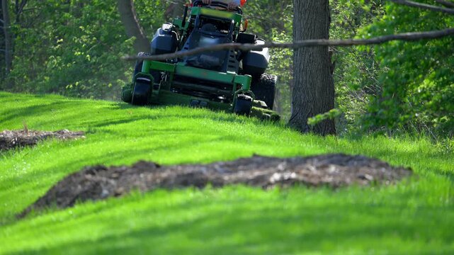 Professional grass cutting service with a large lawn mower, landscaping service. Slow motion
