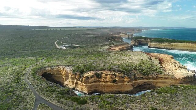 Mutton Bird Island, Great Ocean Road, Port Campbell, Victoria, Australia: 4K aerial drone footage of sea cave, cliffs, coastline and ocean waves near Thunder Cave