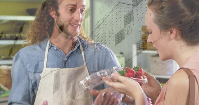 Vendor extending clamshell to customer at market, customer smelling fruit for purchase