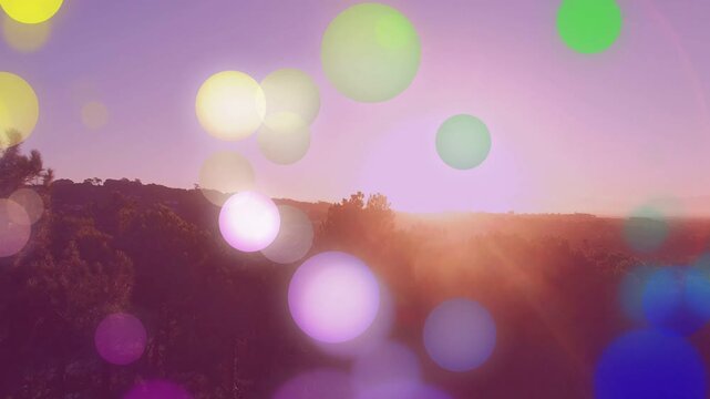 Low sun dipping near horizon causing translucent orbs drifting across ridge and enhancing visuals