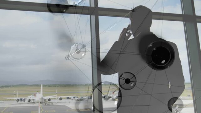 Exec watching parked jet, raising phone and making business call while overlay drifting over him