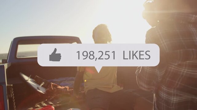 man on truck tailgate turning smiling as friend filming phone, social media likes growing to 900k