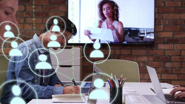 Man writing notes while host showing on screen, icons layering over workspace for business review