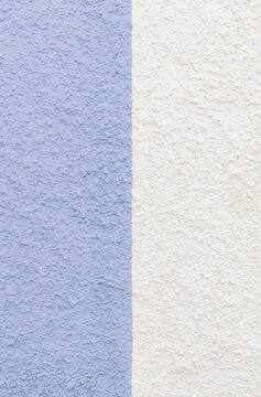 A beautiful view of the street wall with relief trim of a pale lilac-white building.