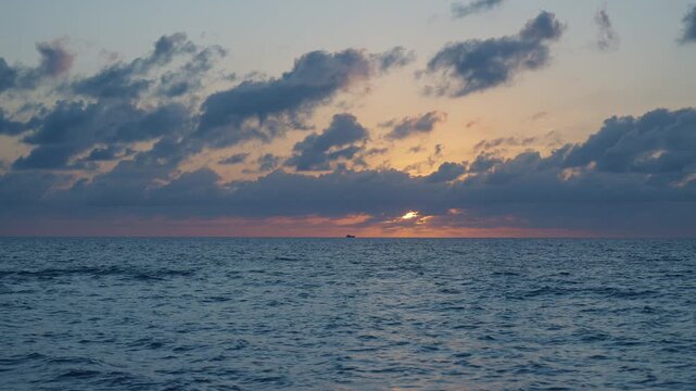 Sea sunset horizon. Sunset cloudy sky. Seascape at summer vacation. Skyscape with sea horizon. Horizon sunrise sea with ship. Sunrise seascape. Romantic summer vacation seascape