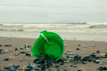 green bucket on beach © cimaron
