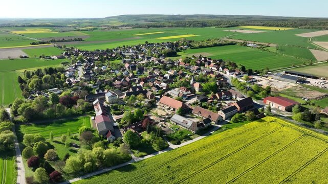 Aerial drone footage of Gro&szlig; Dahlum in Wolfenb&uuml;ttel district, Germany with slow movement over village and farmland landscape
