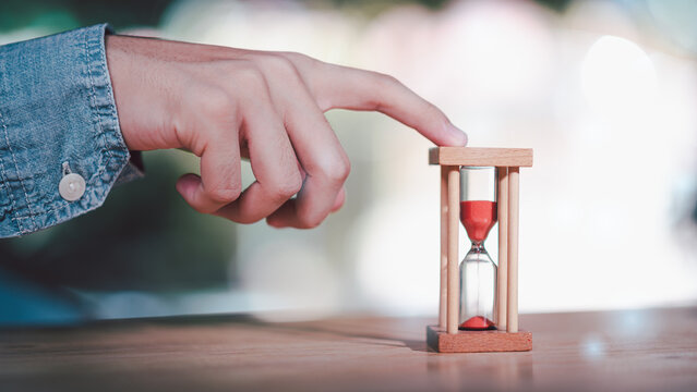 Project manager managing time with hourglass concept for productivity control, deadline tracking, workflow optimization, task prioritization, efficiency planning, business time strategy