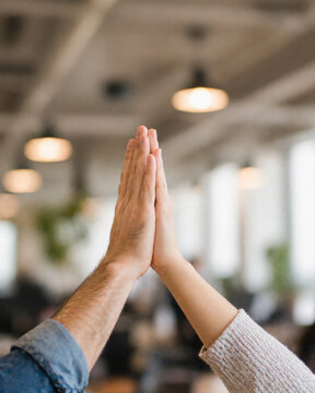 Happy high five hands celebration in office