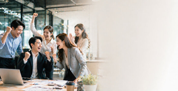 Excited business team celebrating success in office