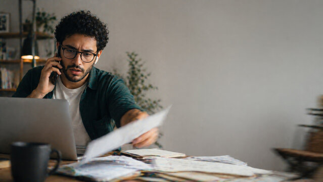 Stressed man working with laptop looking concerned