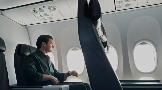 Businessman Fastening Seatbelt on Plane Flight Preparing for Departure