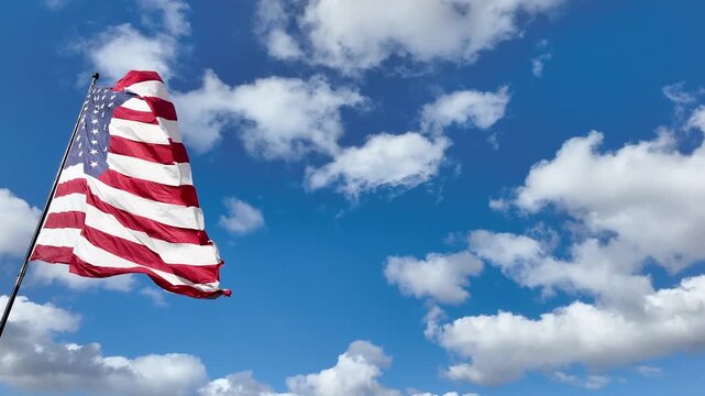 American Flag Blowing in Gentle Wind with Copy Space in Sky