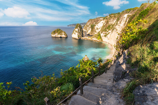 Scenic landscape of a tropical coastline with turquoise water and limestone cliffs at Diamond Beach on Nusa Penida Island, Bali