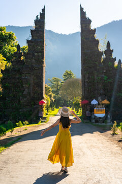 Young woman tourist relaxing and enjoying the beautiful view of the Bali gate in Indonesia