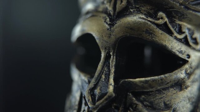 Macro detail of Spartan warrior helmet in slow motion rotation, highlighting metallic texture and moisture