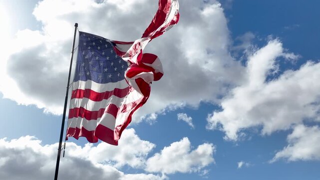 Patriotic American Flag Flying Outdoors Against Dramatic Sky