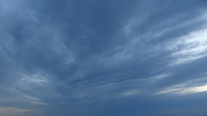 Obraz premium Moody Blue Dawn Clouds and Texture. Detailed view of the sky, featuring dramatic blue and gray cloud textures. A peaceful and meditative atmosphere of early morning light in South Korea.