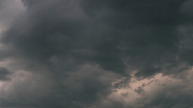Dramatic dark storm thundercloud rain clouds on black sky background. Dark thunderstorm clouds rainny landscape. Meteorology danger windstorm disaster climate. Dark cloudscape storm disaster gray sky