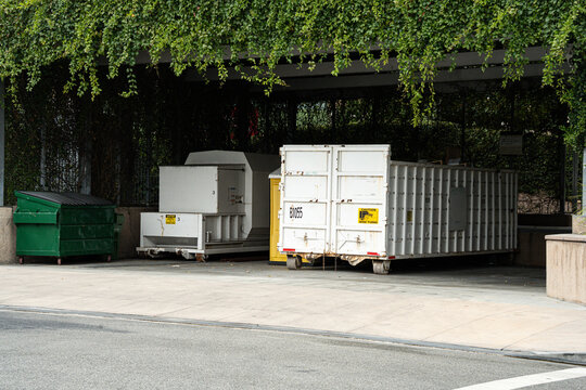 Industrial waste management area with compactors and large containers