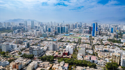 Fototapeta premium Drone photography of the modern business hub in San Isidro, Lima, featuring striking glass skyscrapers and dynamic architectural growth.