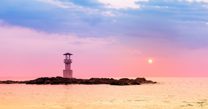 Light house on the rock at sunset beach, tropical beach, architecture on the sea
