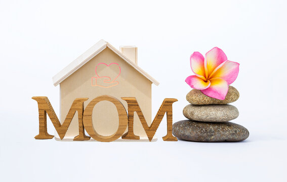 Mom wooden font with house model and flower on stone isolate on white background, Mother's day card background idea