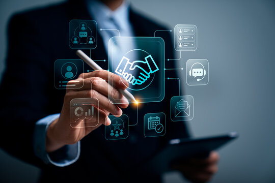 Business professional using stylus interacting with digital handshake icon representing customer relationship management partnership collaboration communication and client engagement technology