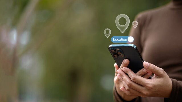 Mobile location tracking and GPS navigation concept with smartphone and geolocation pin icons