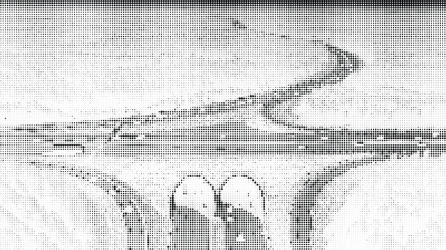 Aerial view of a snow-covered highway interchange with three arches