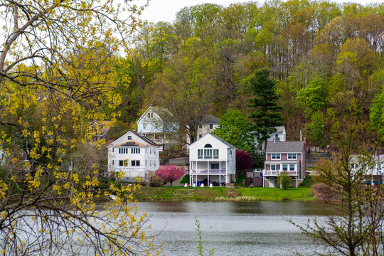 Scenic view of Chandler Pond with waterfront houses and spring foliage in Brighton neighborhood of Boston, Massachusetts