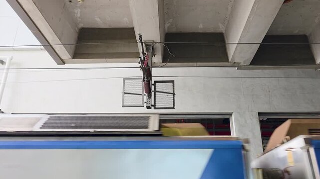 Pantograph on TRA commuter EMU contacting overhead catenary at Taichung Railway Station No 1 Jianguo Rd Central District Taichung City Taiwan with roof equipment in motion, static shot
