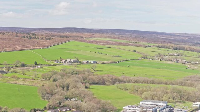 Agricultural landscape near Stocksbridge, South Yorkshire, England, United Kingdom with enclosed pasture fields, hedgerows, scattered farmsteads and moorland hills showing grazing system and land use