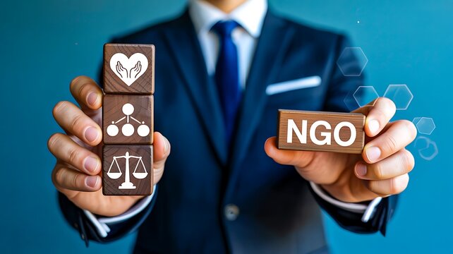 NGO concept with businessman holding blocks representing support ethics and social responsibility