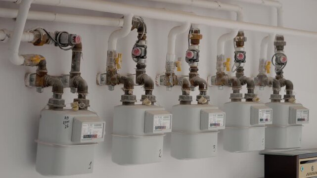This shows gas installations in a block of flats, focusing on the meters and pipes. It highlights the setup and connections used for gas supply in the building.