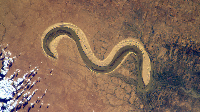 Winding river in arid landscape emphasizing natural beauty and tranquility