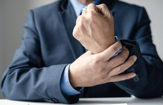 man hand with wrist pain numbness and pain in the palm of the hand has pain and tingling in the nerve endings This is a side effect of sitting and working for a long time on a laptop at the office