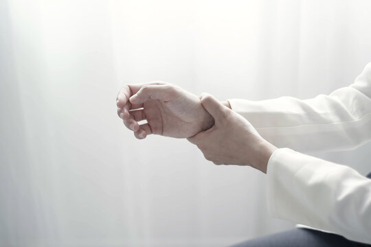 Woman hand with wrist pain numbness and pain in the palm of the hand has pain and tingling in the nerve endings This is a side effect of sitting and working for a long time on a laptop at the office