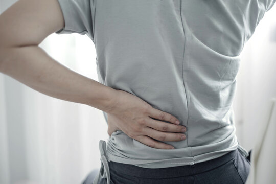 Woman having back body pain during work long time. stretching to relax and relax while working hard at the office