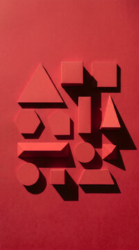 Red 3D Geometric Shapes with Harsh Shadows on Red Background