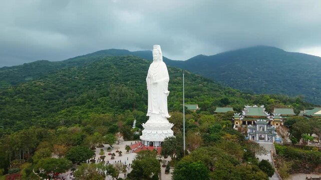 Lady Buddha statue in Linh Ung Pagoda Da Nang Vietnam stands tall overlooking sea and mountains. Spiritual icon Lady Buddha represents mercy peace and protection and attracts tourists and pilgrims.
