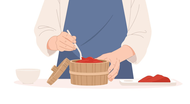 Person preparing kimchi, stirring red paste in traditional wooden barrel, close-up