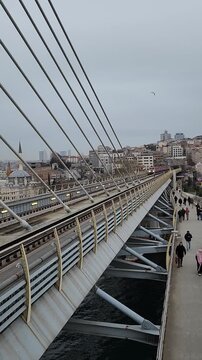 Beautiful aerial footage of the Halic tram passing through Istanbul with iconic mosque architecture in the background. Urban travel scenery with cultural city atmosphere.