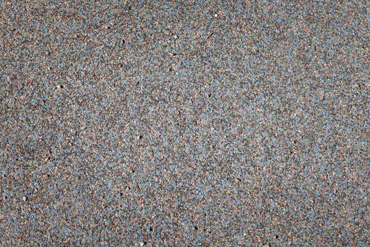 Yellow road covering made of rubber crumb for a sports ground. Synthetic grainy rubber flooring, surface coating for playground