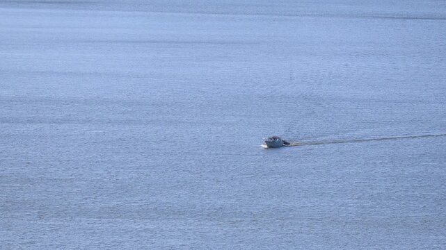 Cruise ship sailing offshore far away on the big blue sea