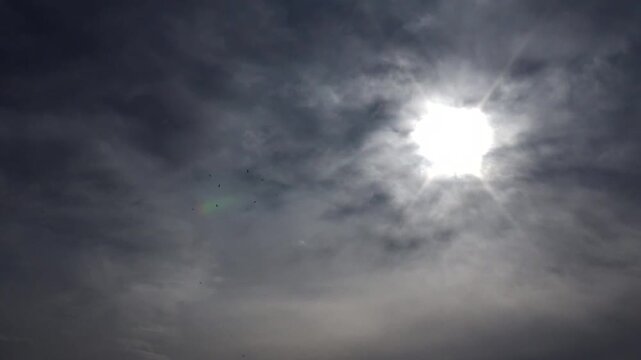  Bright sunlight breaking through cloudy sky expressing nature�s contrast of light and shadow, representing hope, energy, and beauty of atmospheric patterns above. 